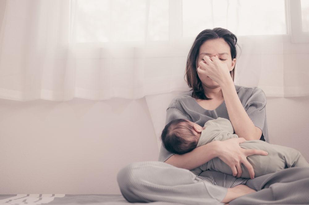 sleep deprived mom caring for baby