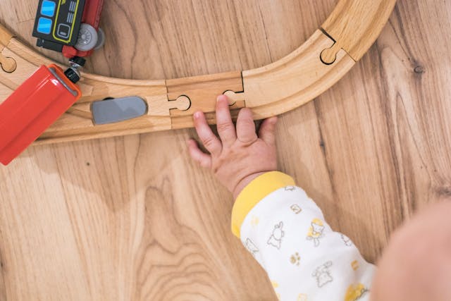 A baby playing with toys on the floor