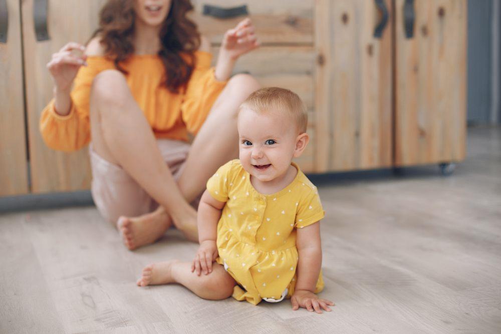 A mother enjoying playtime with her child after baby-proofing the home.