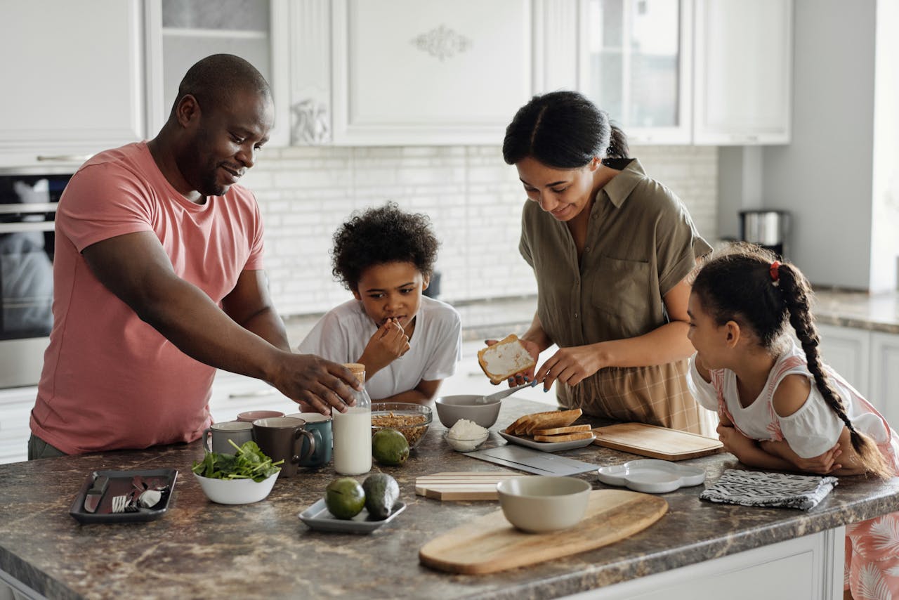 A family in the kitchen preparing breakfast